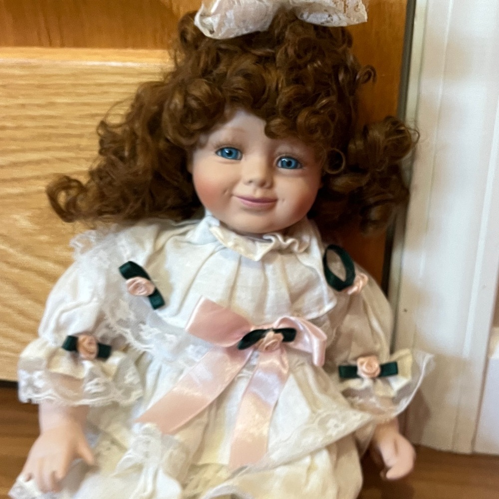 Charming Porcelain Doll with Auburn Curls and White Dress